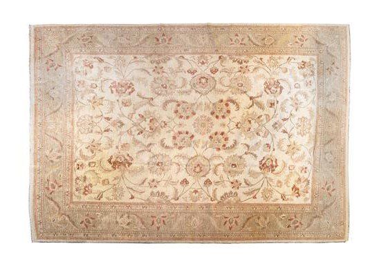 A rug with a floral pattern on it is on a white background.