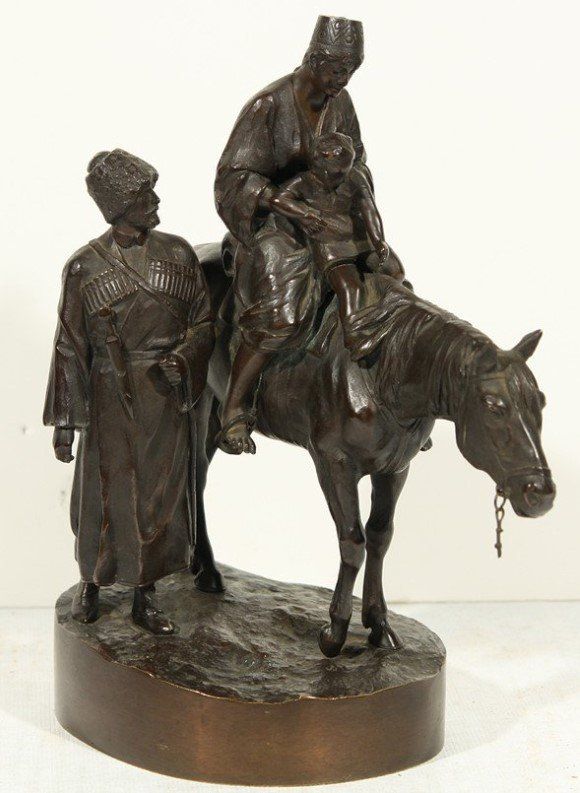 A statue of a man riding on the back of a horse