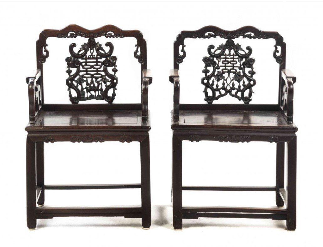 A pair of chairs with chinese writing on the back