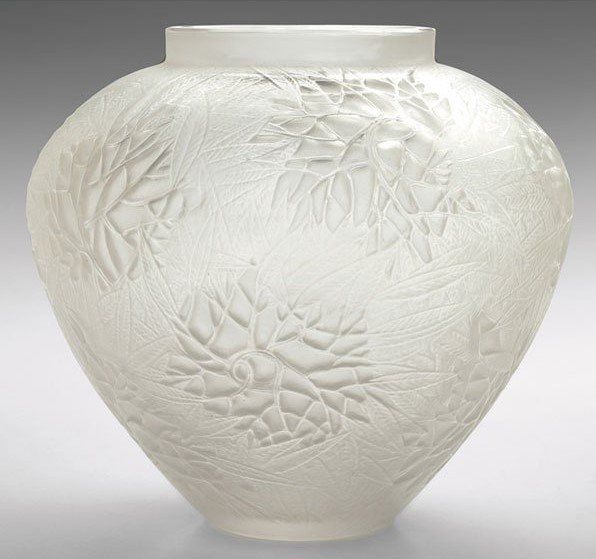 A white vase with a floral design on it