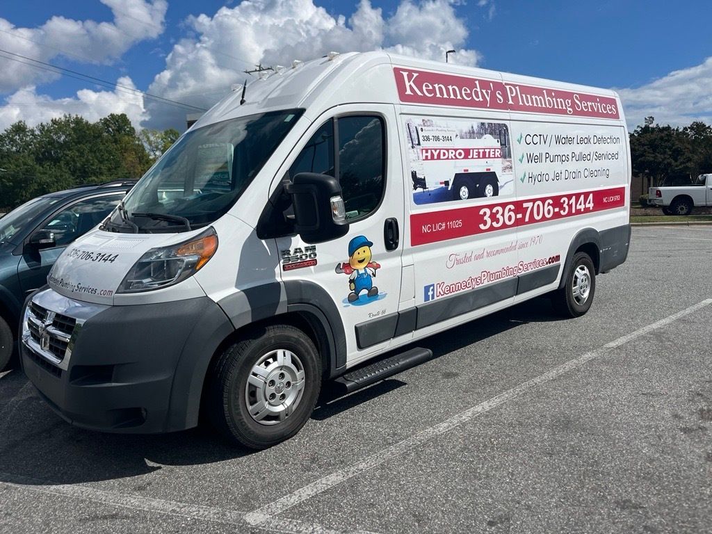 A white van is parked in a parking lot.