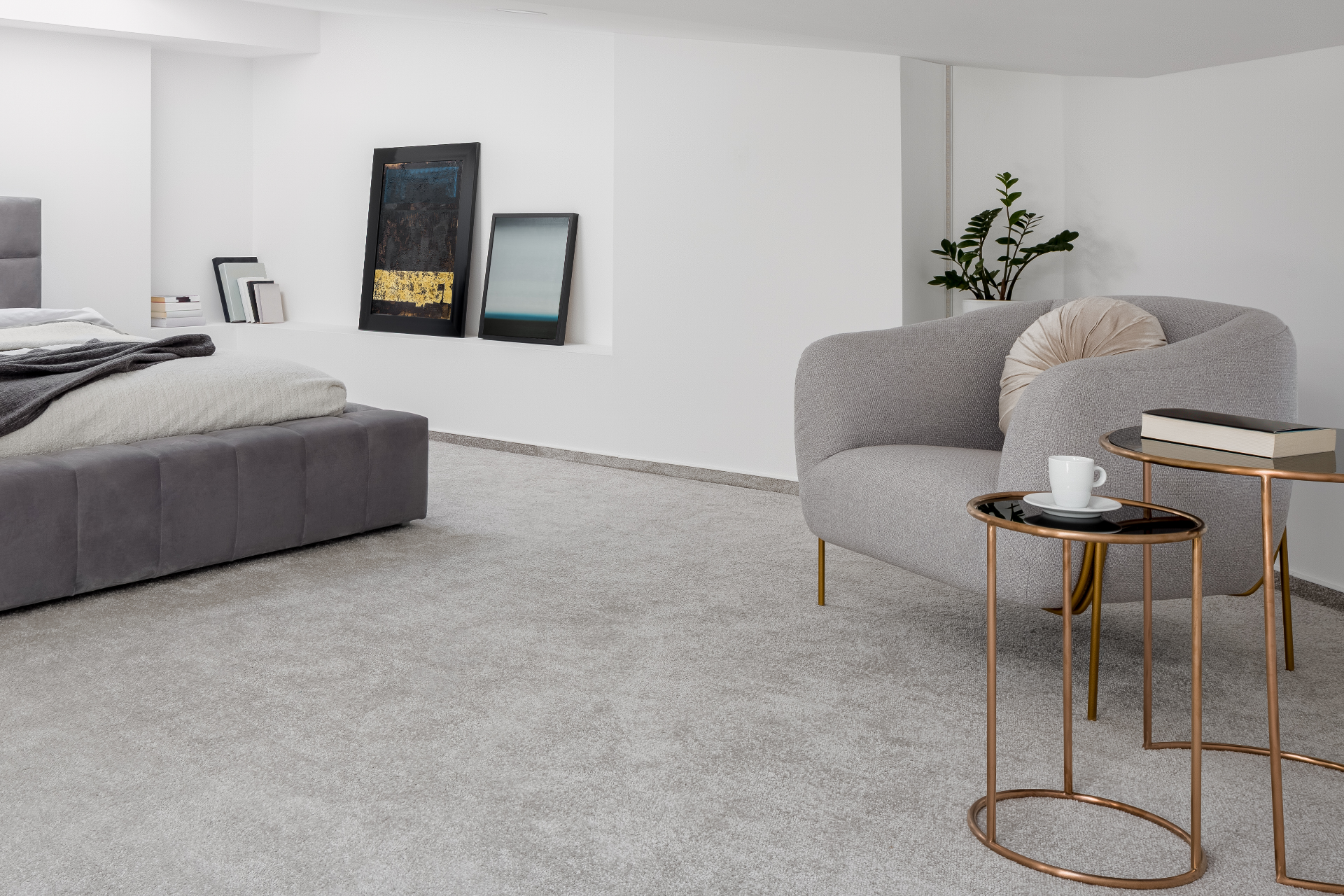 A bedroom with a bed , couch , and table.