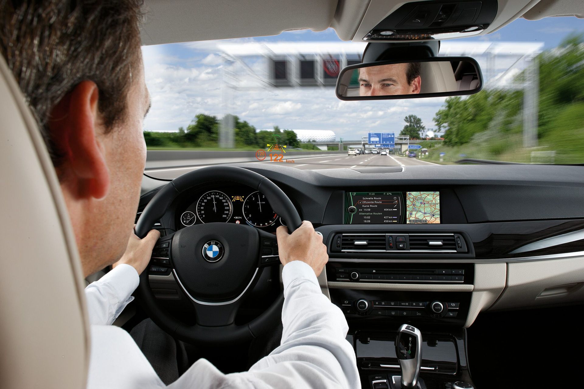 A man is driving a bmw on a highway