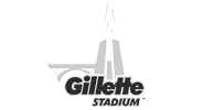 A black and white logo for gillette stadium with a bridge in the background.