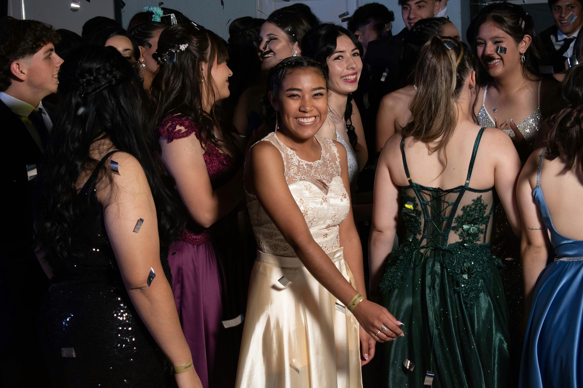 A group of women in dresses are standing in a room.