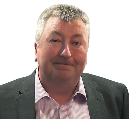 A man in a suit and striped shirt is smiling for the camera