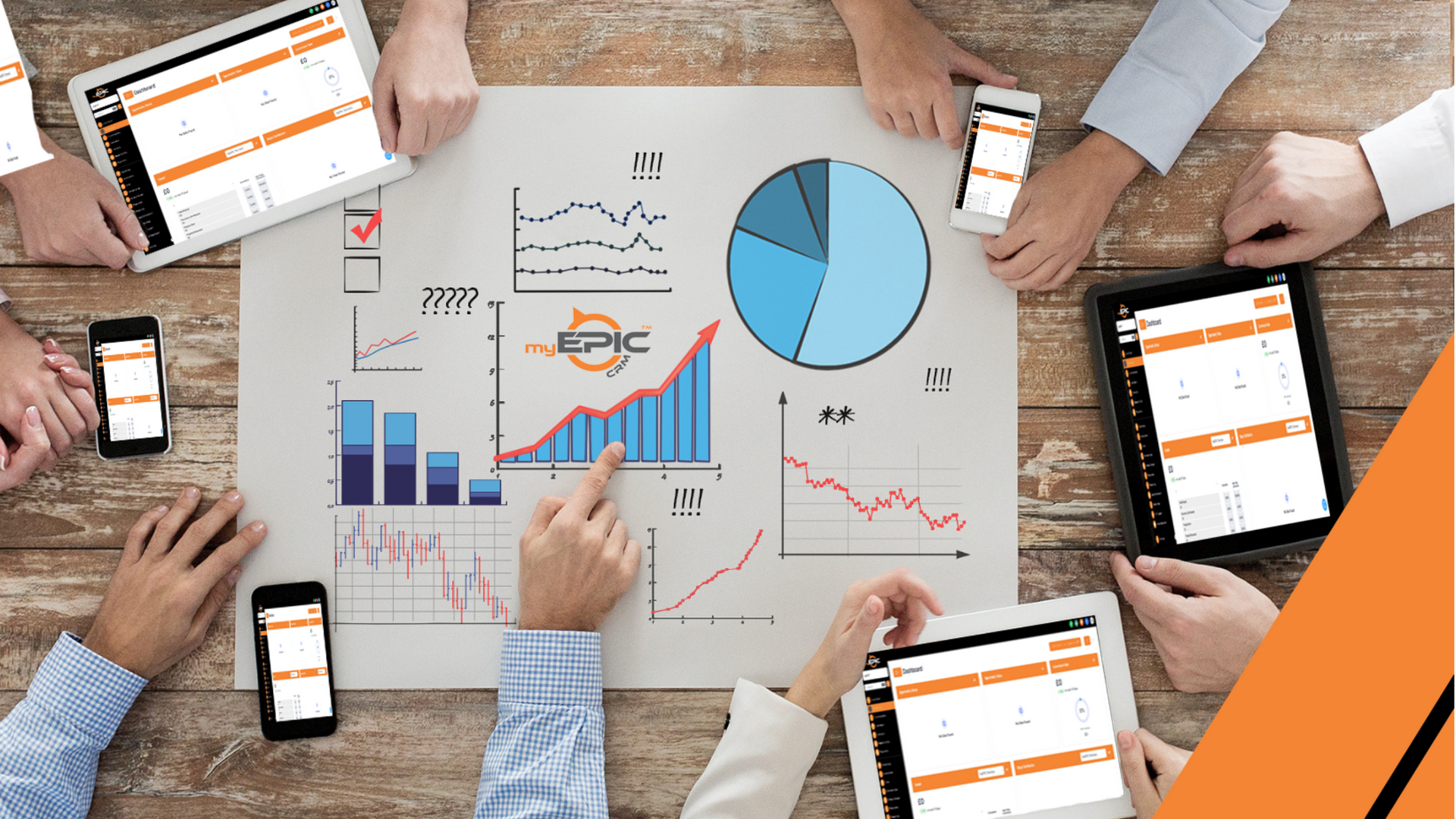 A group of people are sitting around a table looking at charts and graphs.