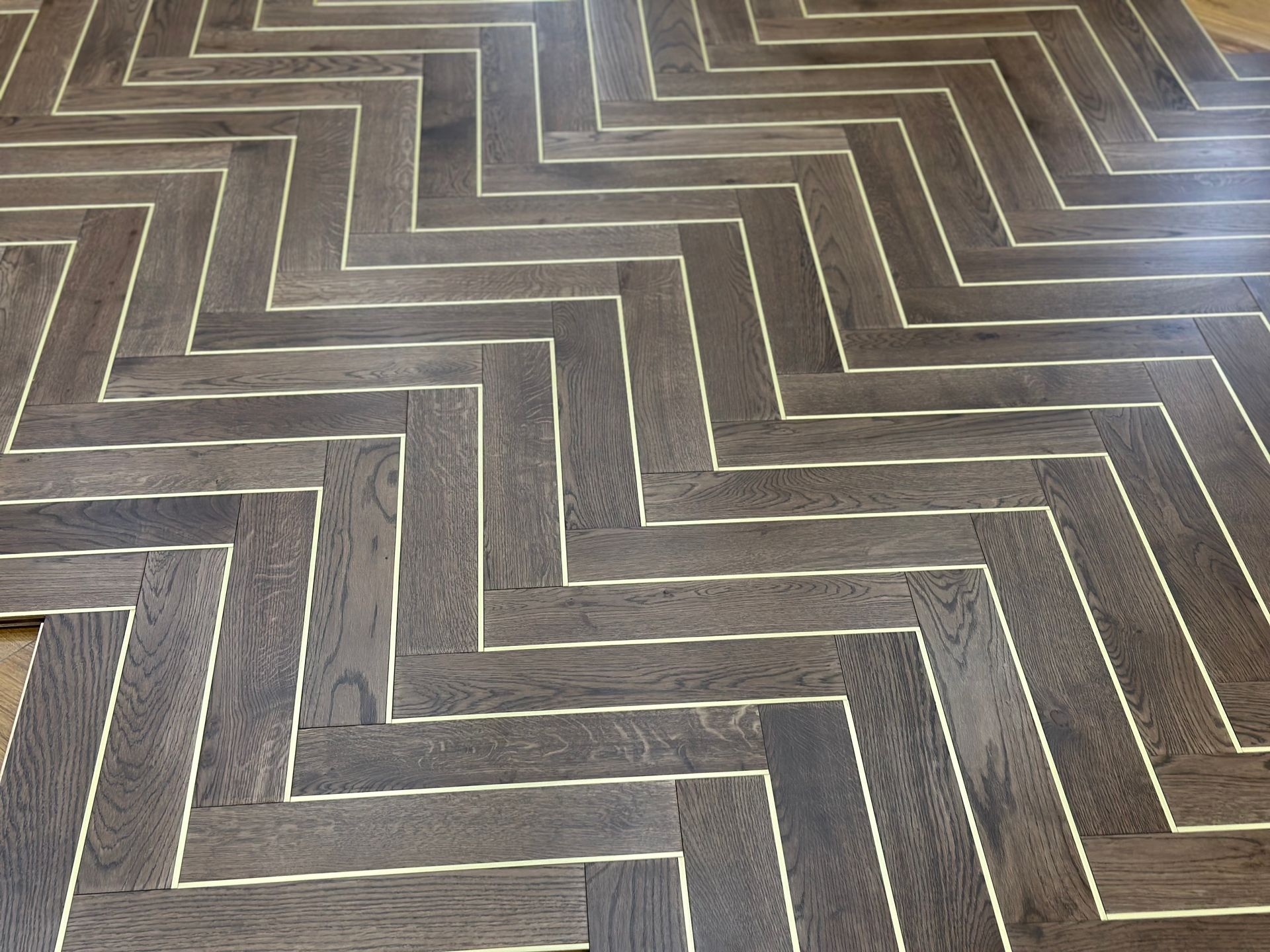 Herringbone flooring with metal inlay. 
