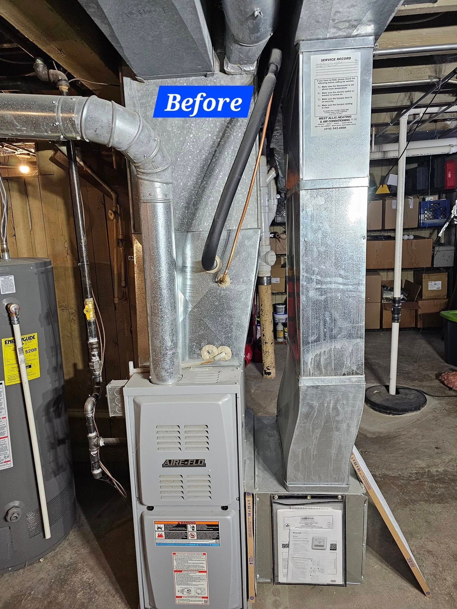A before picture of a furnace in a basement.
