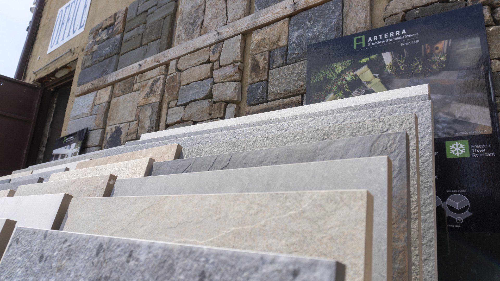 A stack of tiles sitting on top of each other in front of a stone wall.