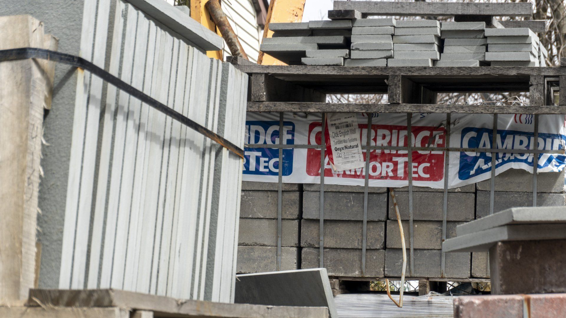 A stack of bricks with a sign that says edge tec