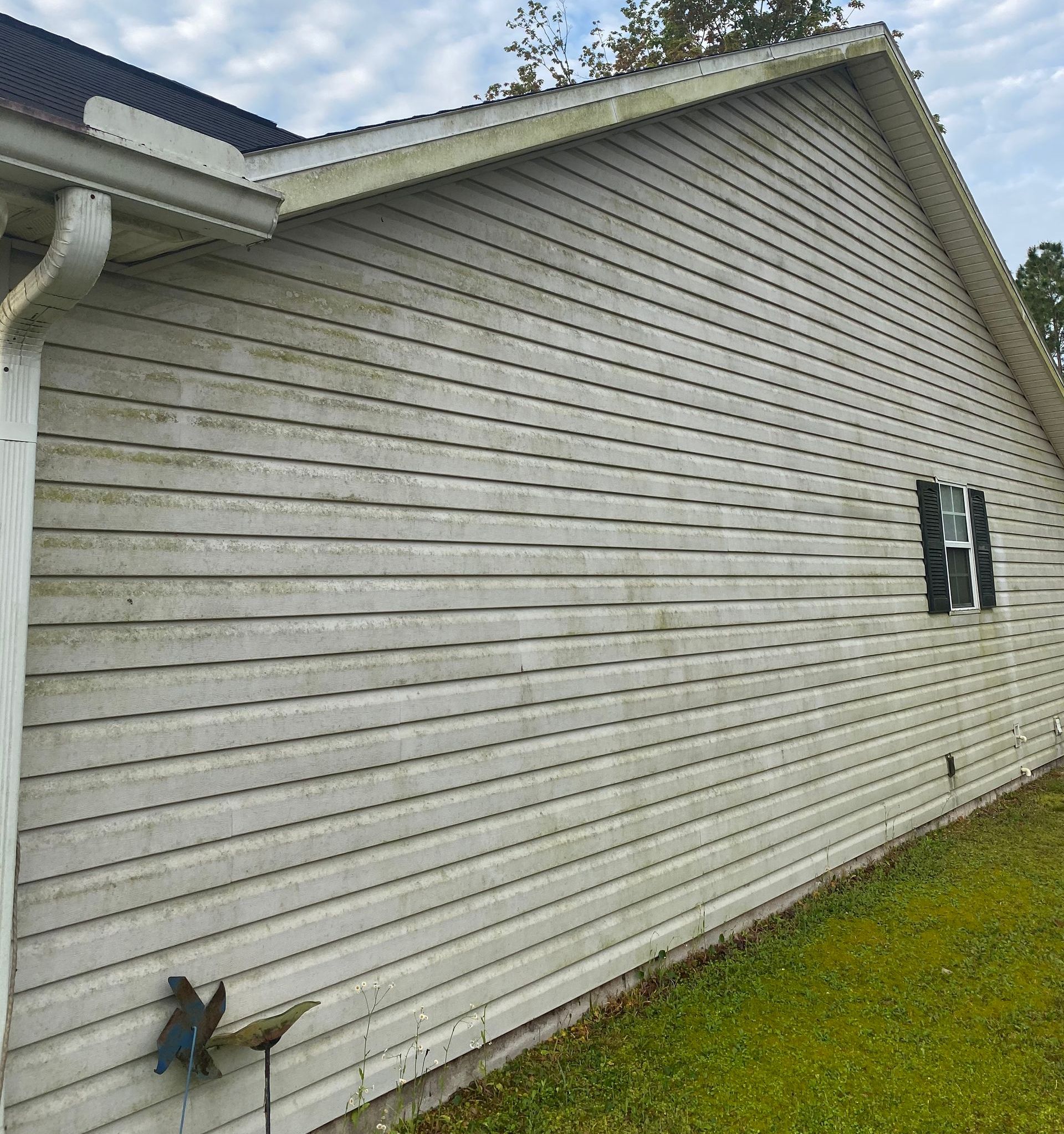 The side of a house with a lot of stains on it.