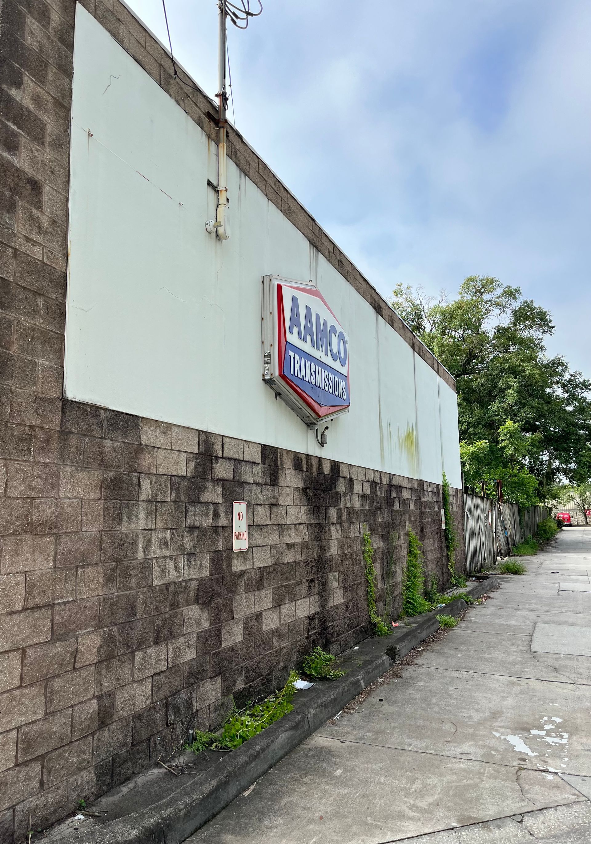 A large brick wall with a sign on it.