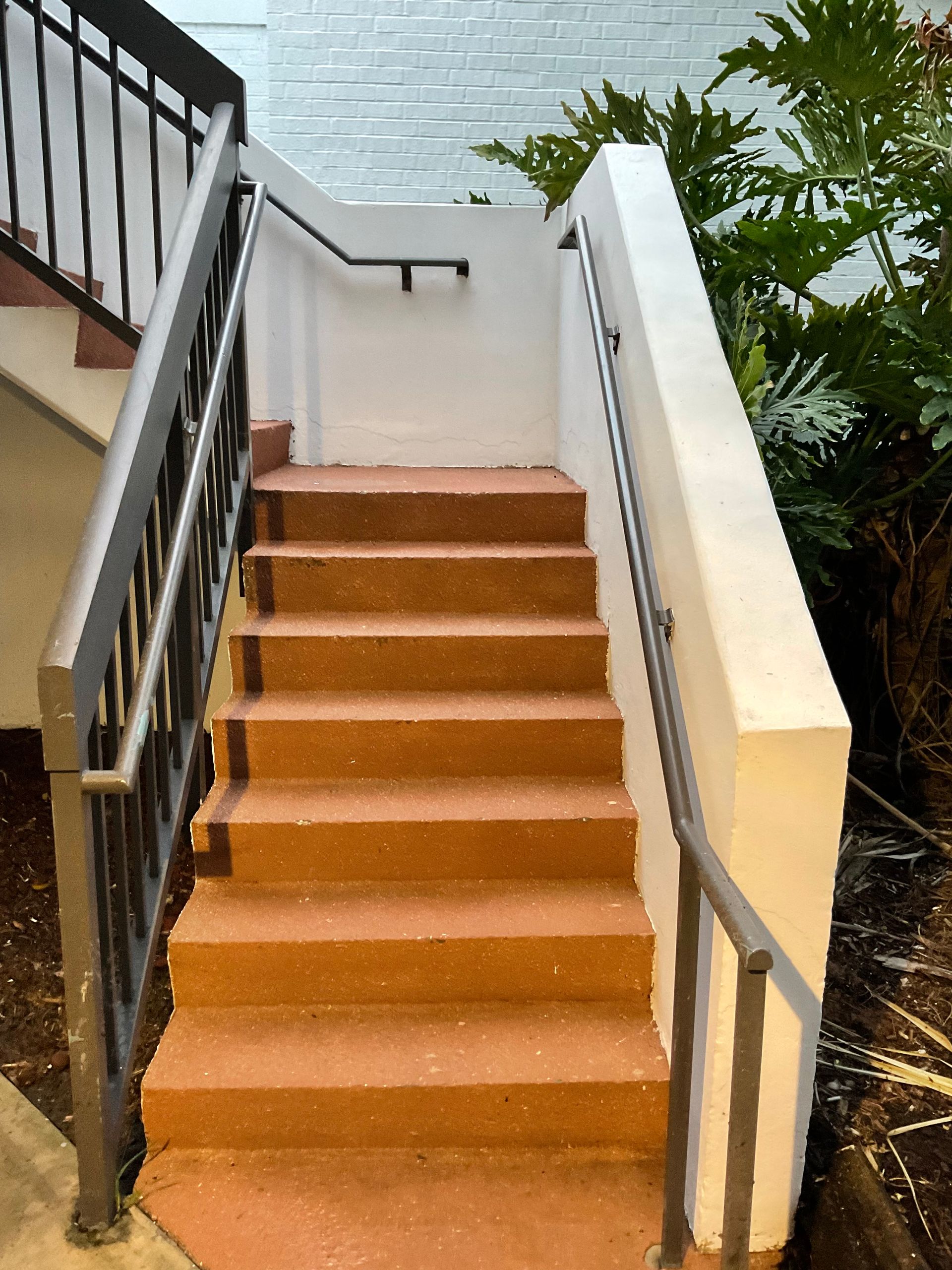 A set of stairs leading up to a building with a railing