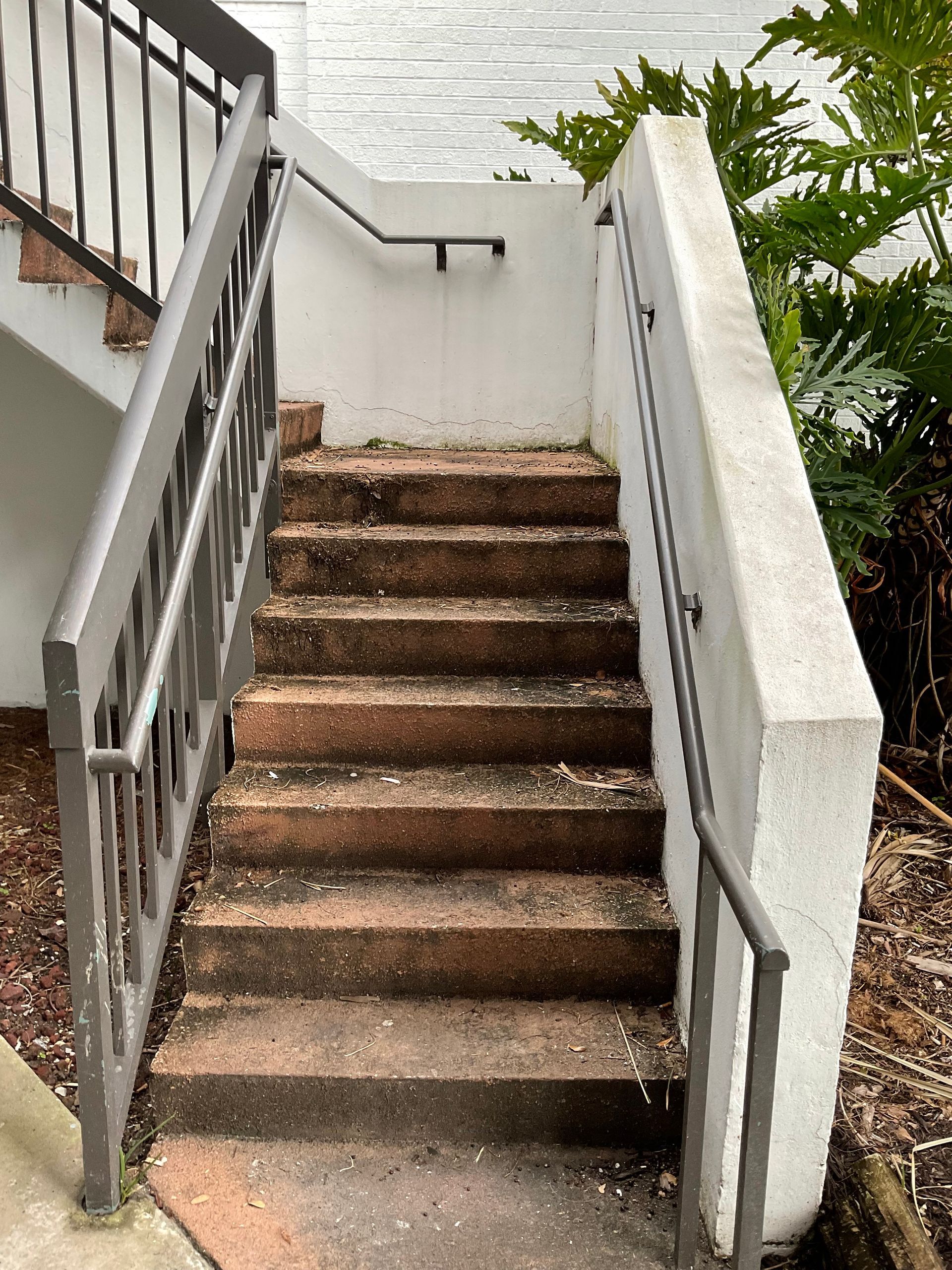 A set of stairs leading up to a building with a railing.