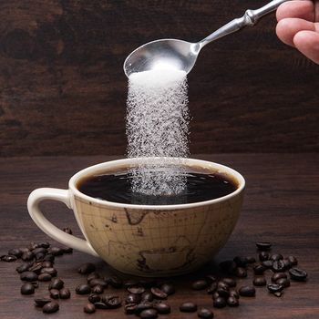 Sugar Pours Into Coffee Cup — Cadillac, MI — All Beans Coffee Company