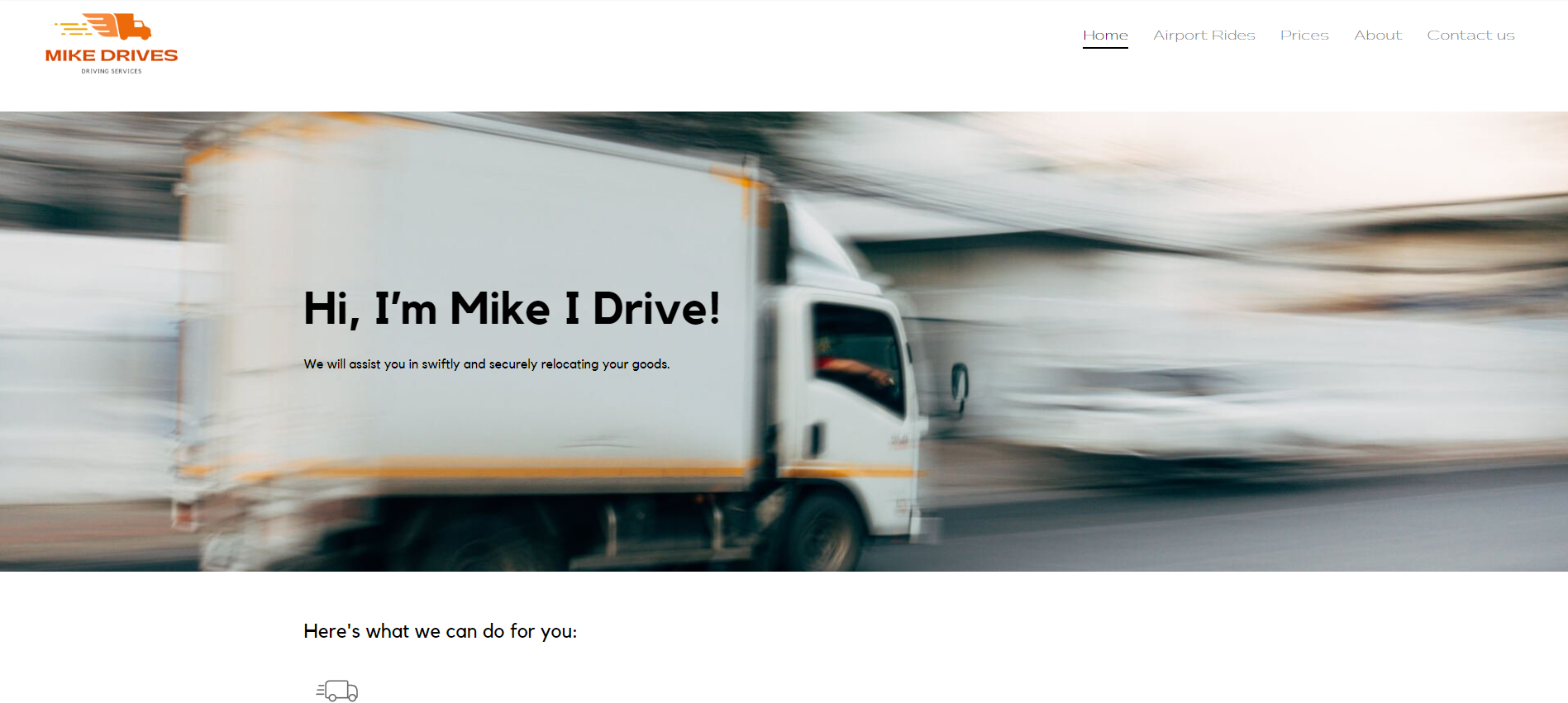 A white truck is driving down a road.