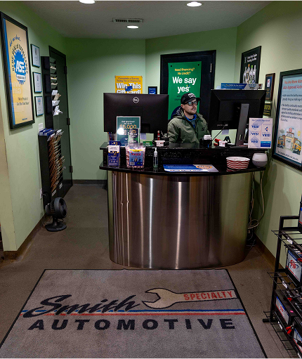 A person sits at a desk at smith automotive | Smith Specialty Automotive