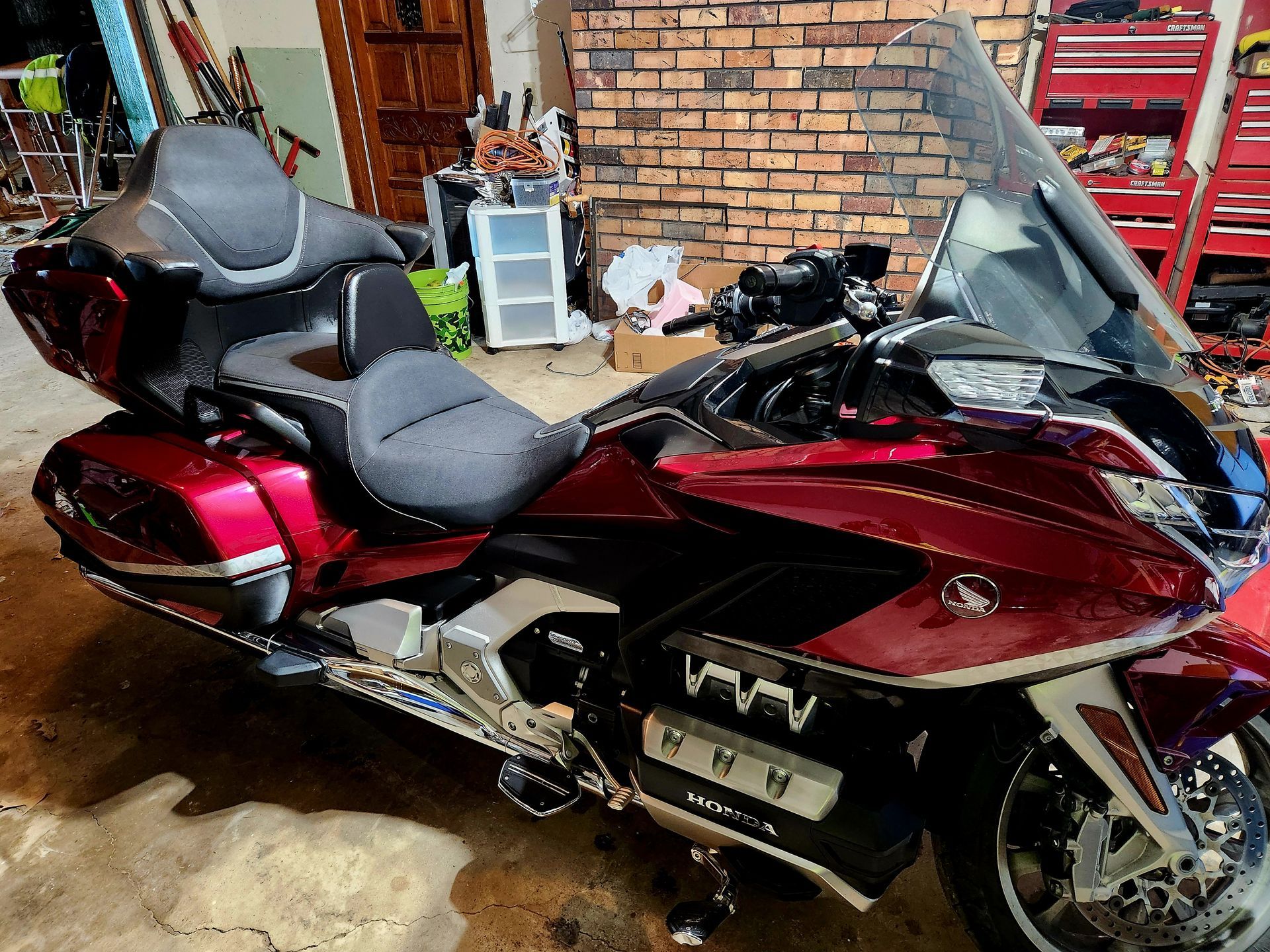 Red Honda Goldwing motorcycle parked indoors.