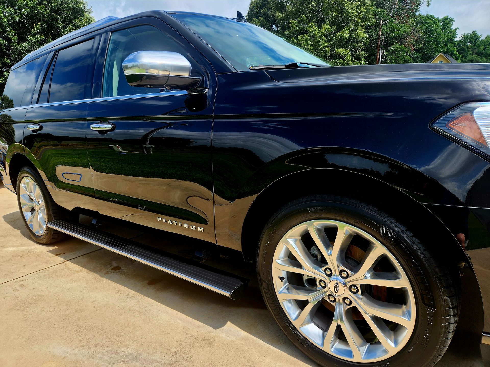 Black Ford Expedition SUV parked on concrete.