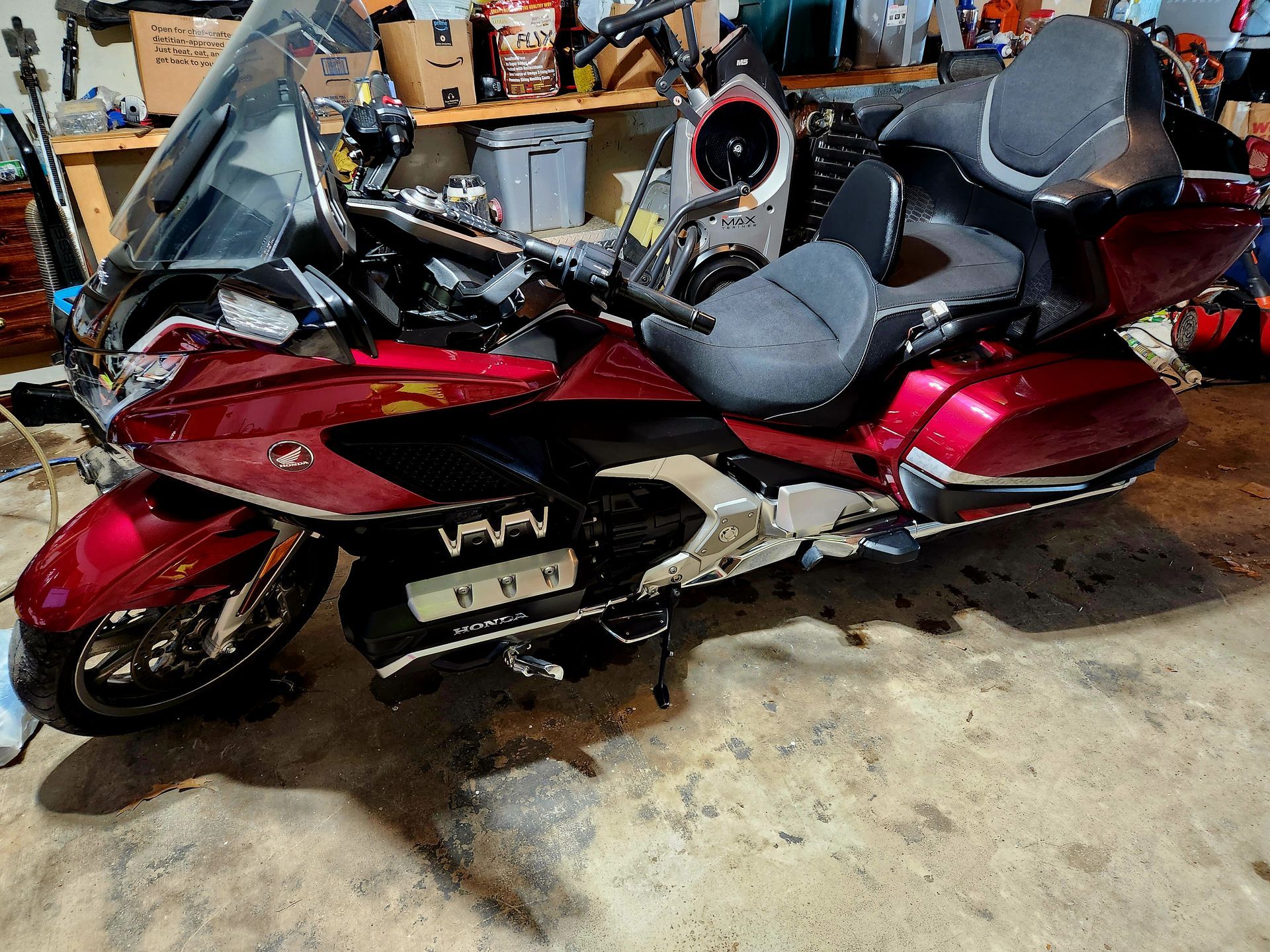 A red and black Honda Goldwing motorcycle parked in a garage.