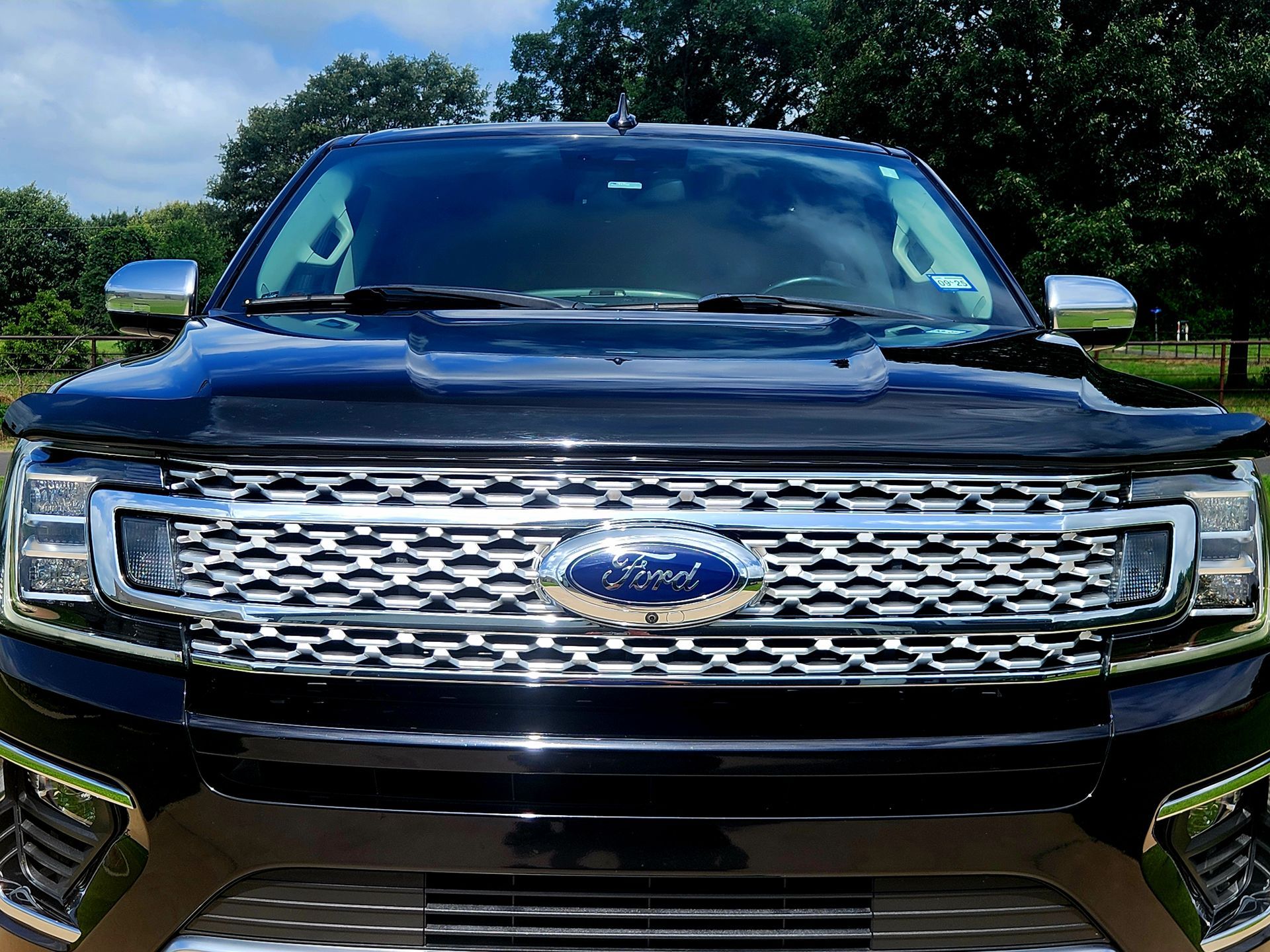 Black Ford Expedition SUV with chrome accents, parked outdoors.