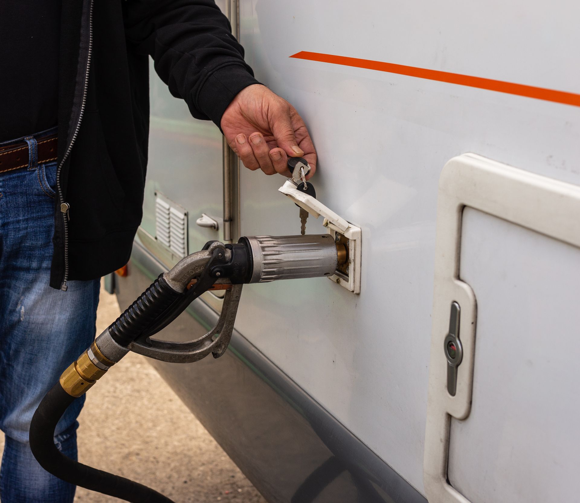 A person is using a hand sanitizer dispenser.