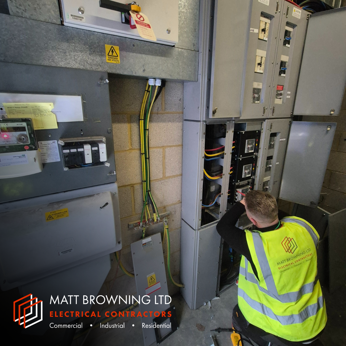 An NICEIC Approved Contractor electrician inspection an electrical distribution board as part of a commercial EICR at a warehouse in Reading Berkshire