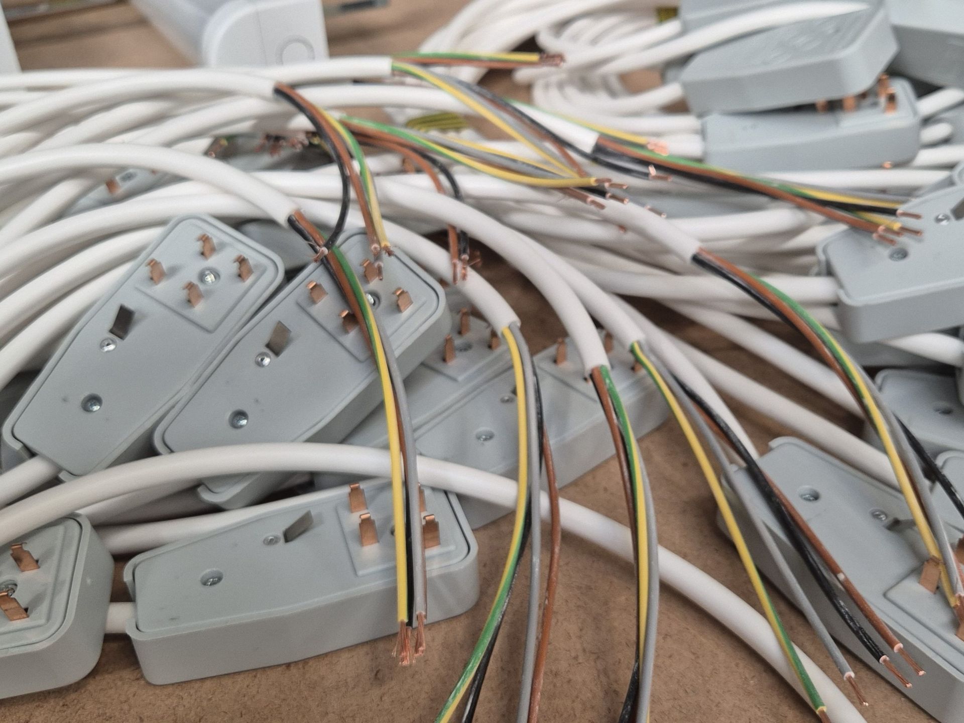 Flexible electrical cables stripped and prepared with bus bar trunking tap-off plugs wired, ready for installation of a commercial LED lighting installation designed and installed by Matt Browning Electrical Contractors based near Bracknell & Wokingham.