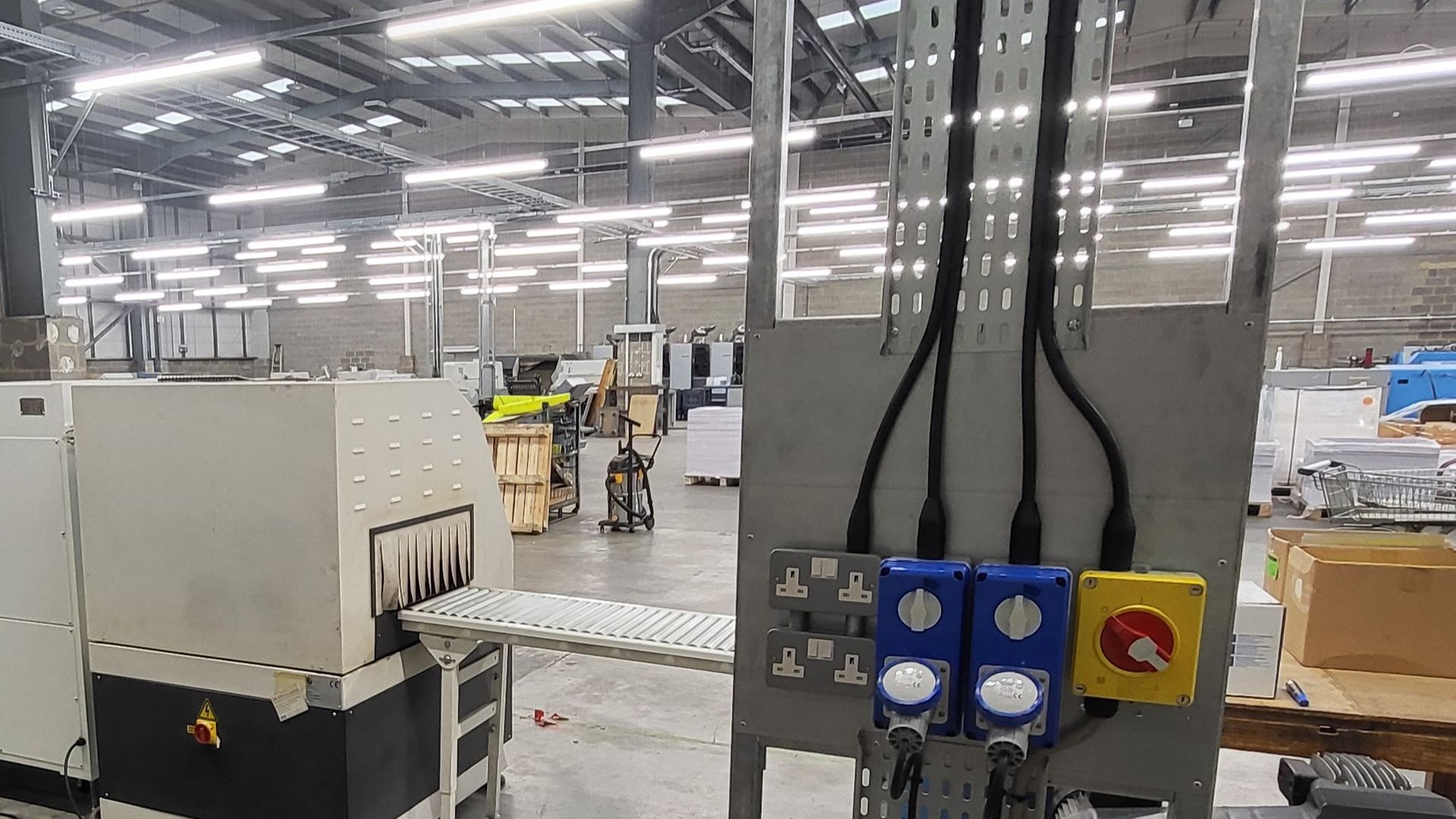 Industrial electrical rotary isolators and industrial sockets installed on a steel workstation post to connect electrical supplies to packing machines at a factory near Reading and Maidenhead, installed by the commercial industrial electricians at Matt Browning Electrical based near Wokingham and Bracknell.