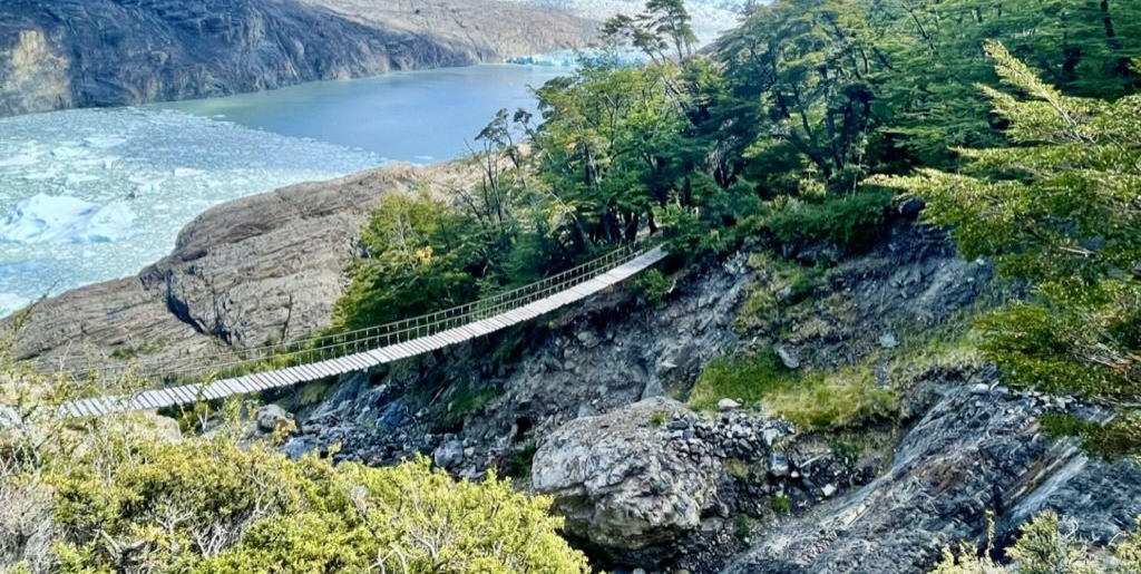 Image of wooden rope bridge across a rocky ravine.