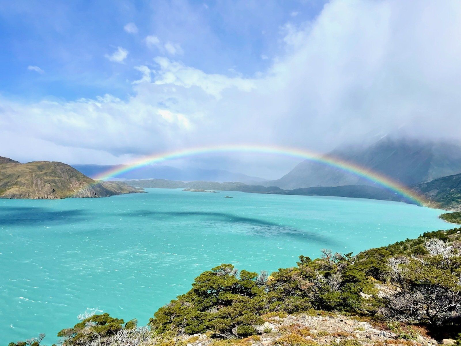 Beautiful, full rainbow over Caribbean blue water.