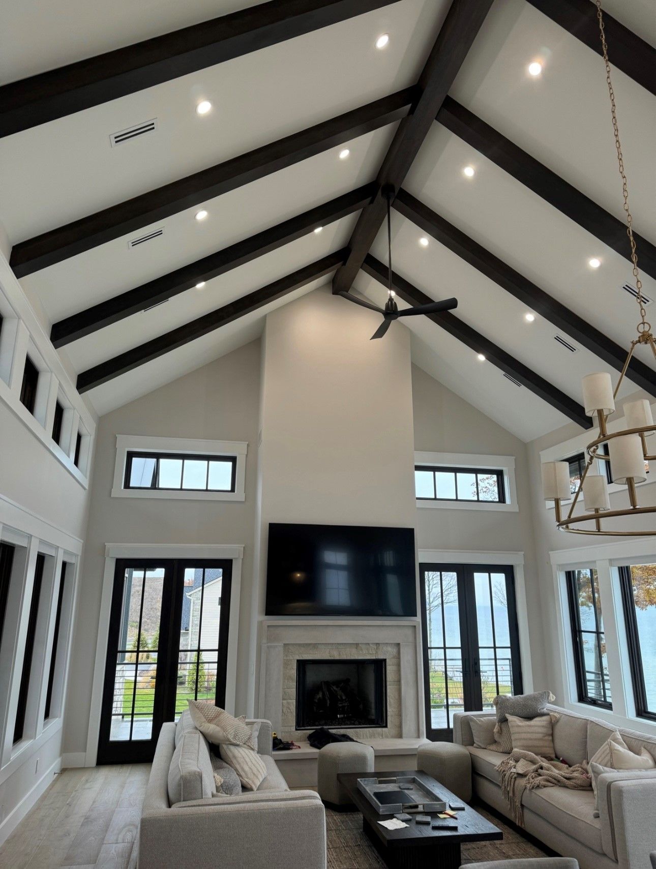 A living room with a vaulted ceiling and a fireplace.