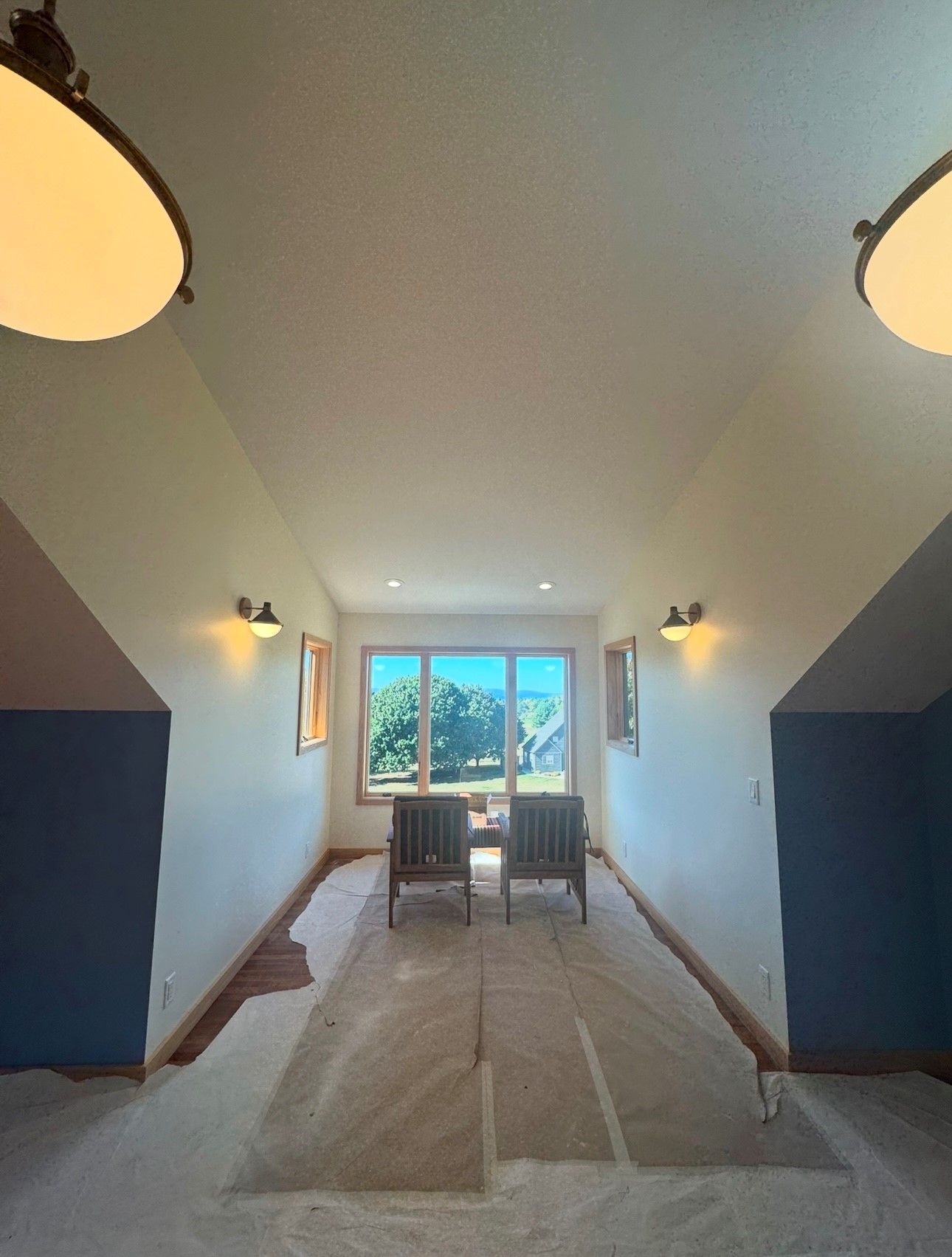 A room with a lot of windows and chairs in it