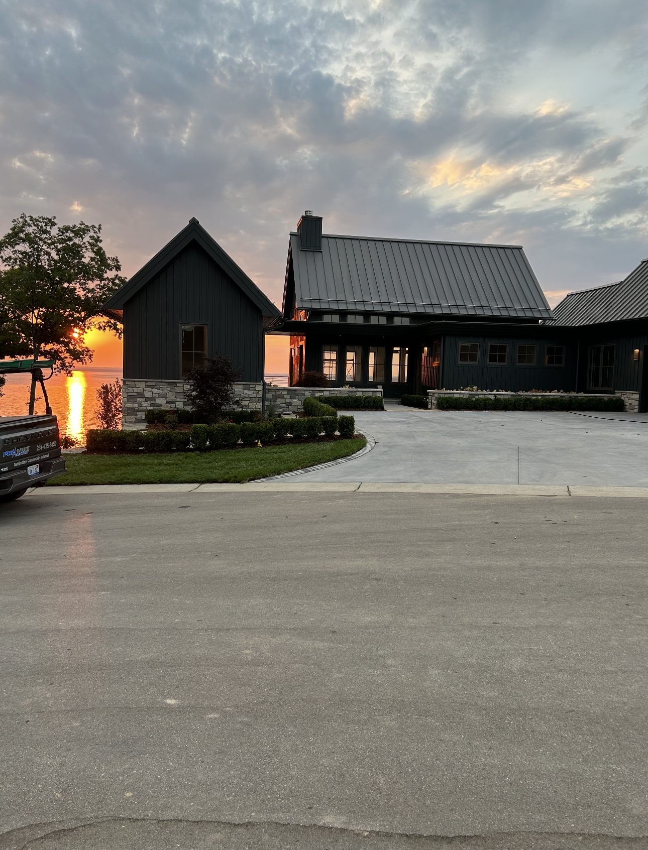 A truck is parked in front of a large house