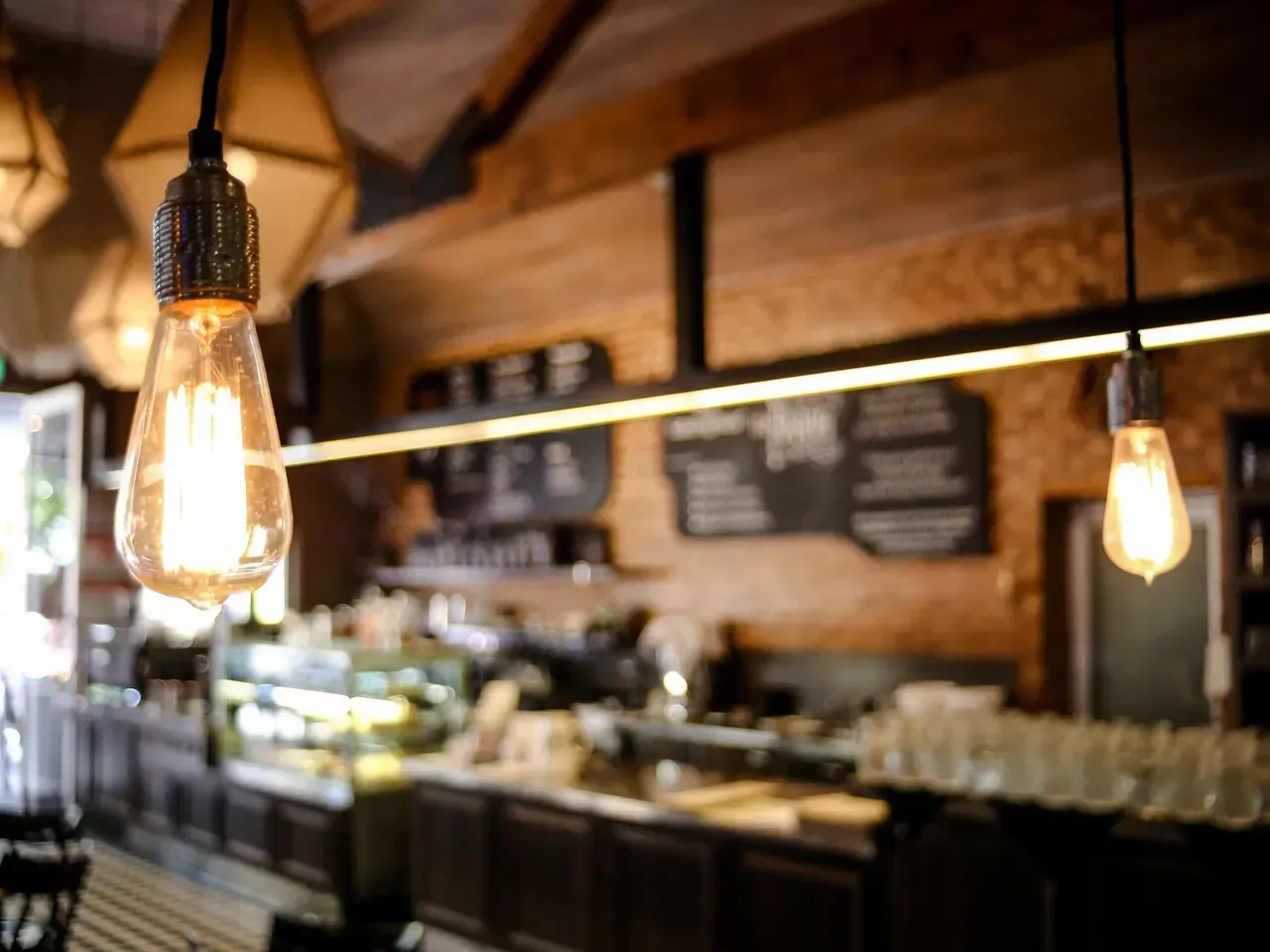 A restaurant with a lot of lights hanging from the ceiling