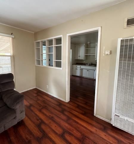 a kitchen with a table and chairs in front of a window .