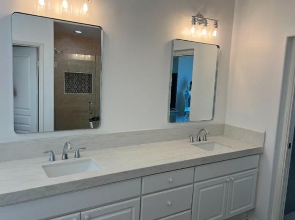 a man is installing a counter top in a kitchen .