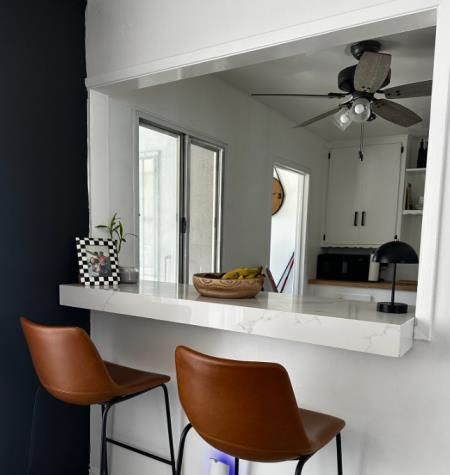 a kitchen with a table and chairs in front of a window .