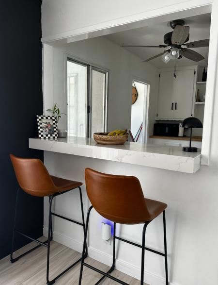 a man is installing a counter top in a kitchen .