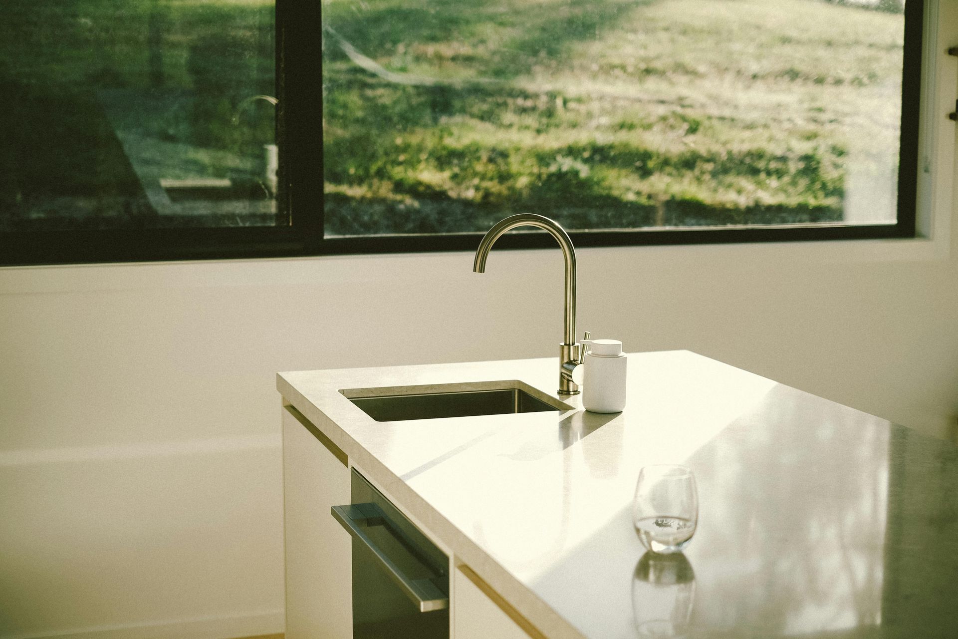 a kitchen with a table and chairs in front of a window .