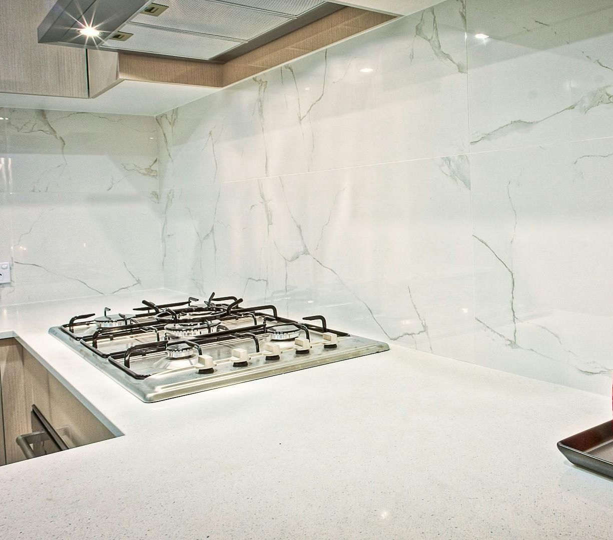 a man is installing a counter top in a kitchen .