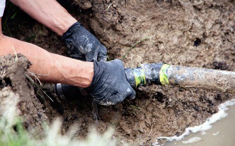 Septic Cleaning — Working Doing Repair On The Septic Hose In Bryan, TX