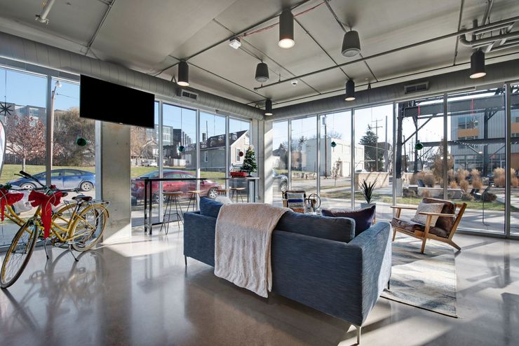 A  room with a couch , chairs , and a television.