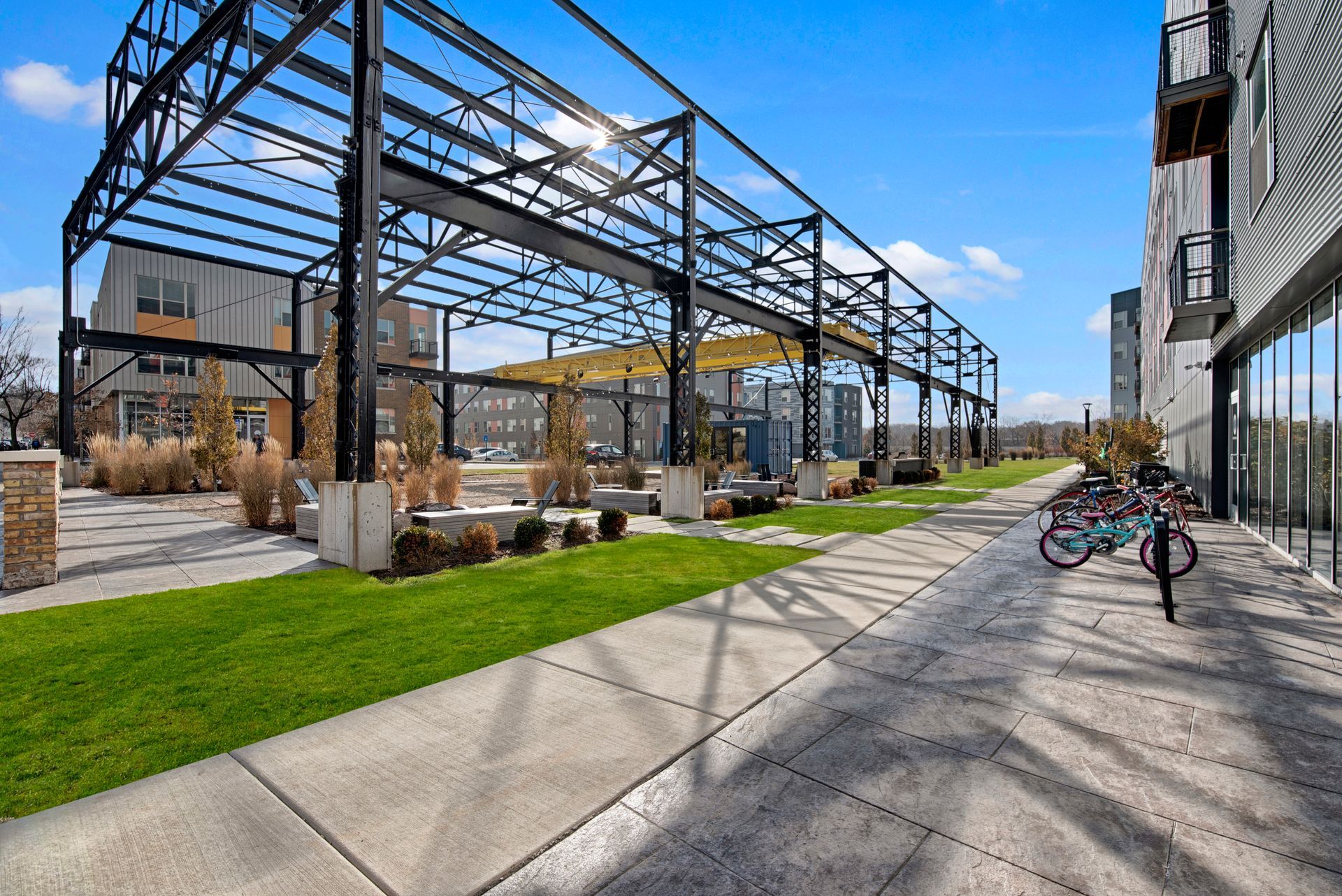 A bicycle is parked on the sidewalk in front of a building.