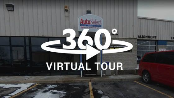 A virtual tour of an auto repair shop with a red van parked in front of it.