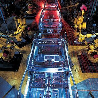 A car is being built in a factory with robots.