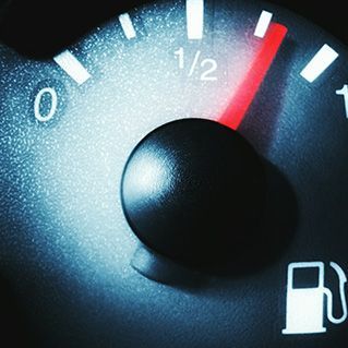 A close up of a fuel gauge showing that it is half full