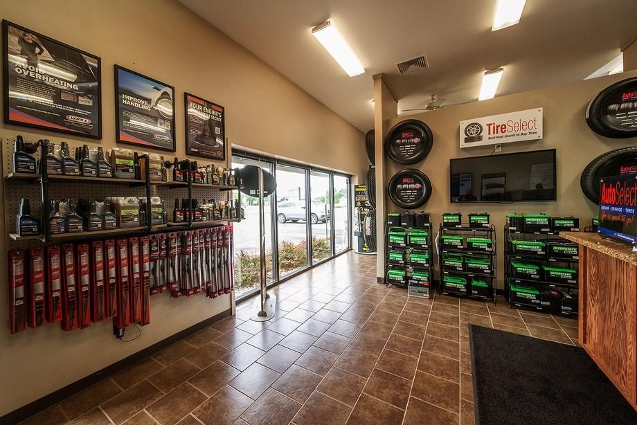 A large room with a lot of shelves and tires on the wall.