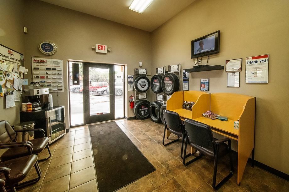 A waiting room with a lot of tires on the wall.